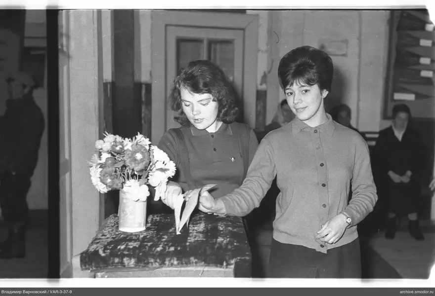 Two women at a table with flowers
