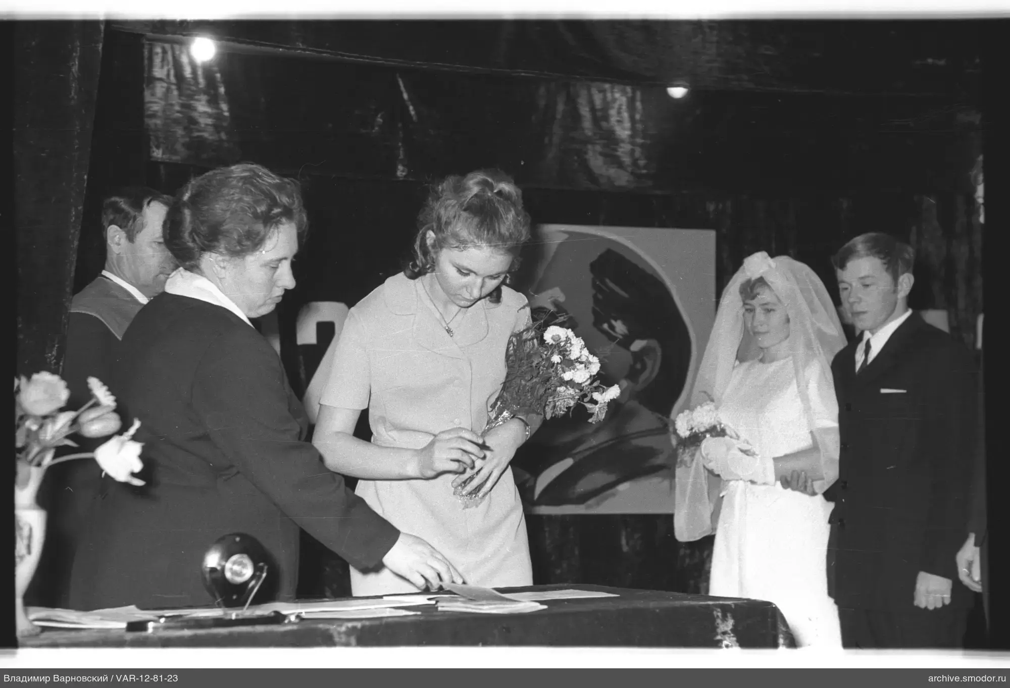 Woman signing a document at the table