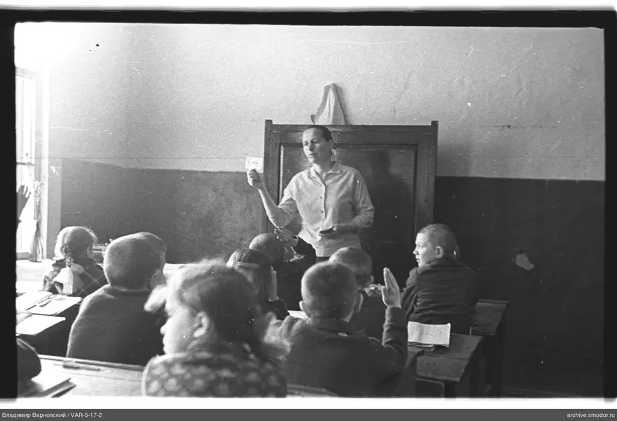 Frau mit Karte an der Tafel im Klassenzimmer