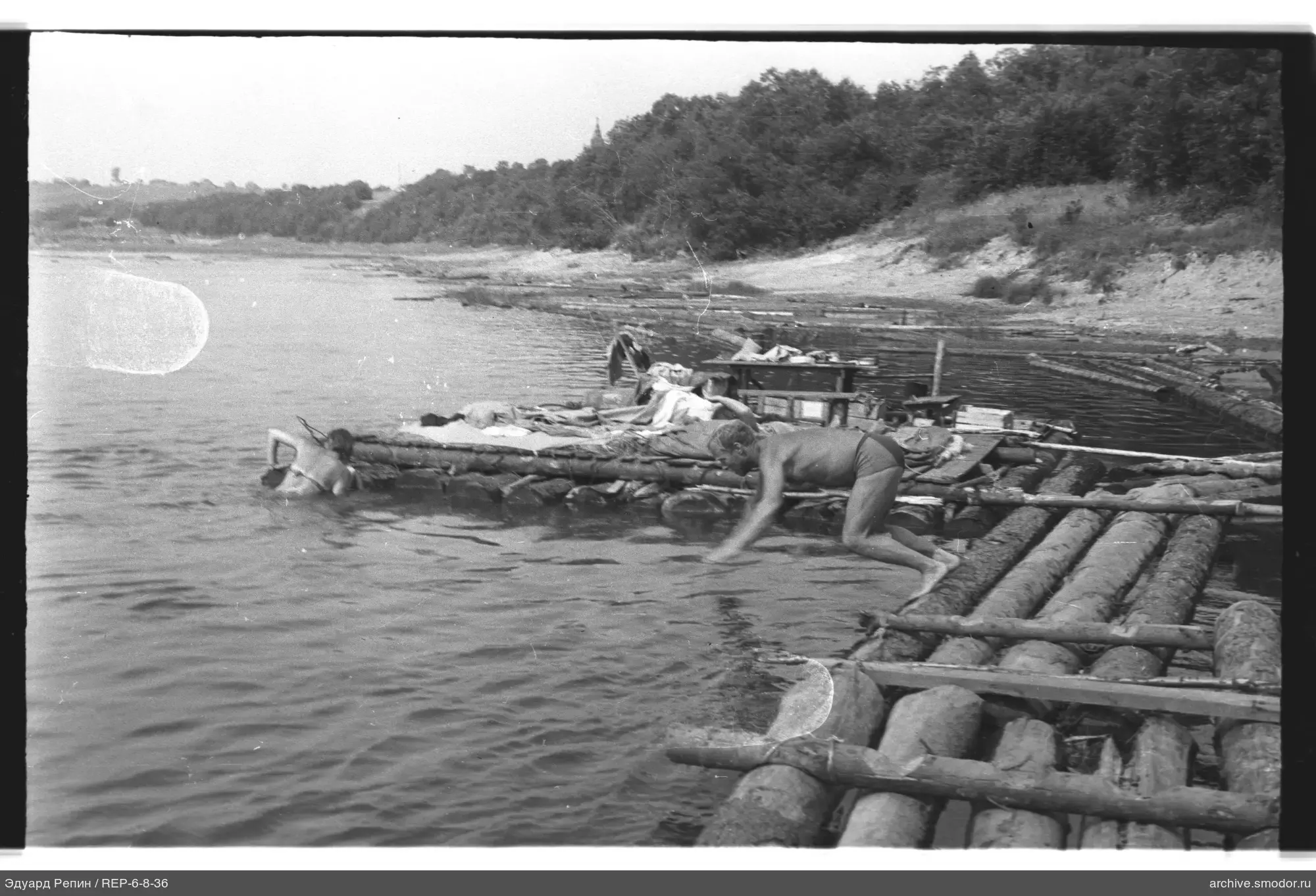 Men on rafts and in water