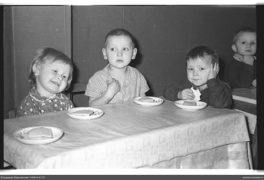 Group portrait of children at tables