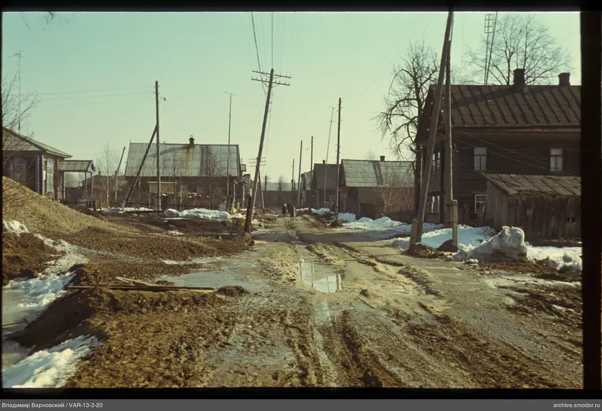 Dirt road with houses and electric wires