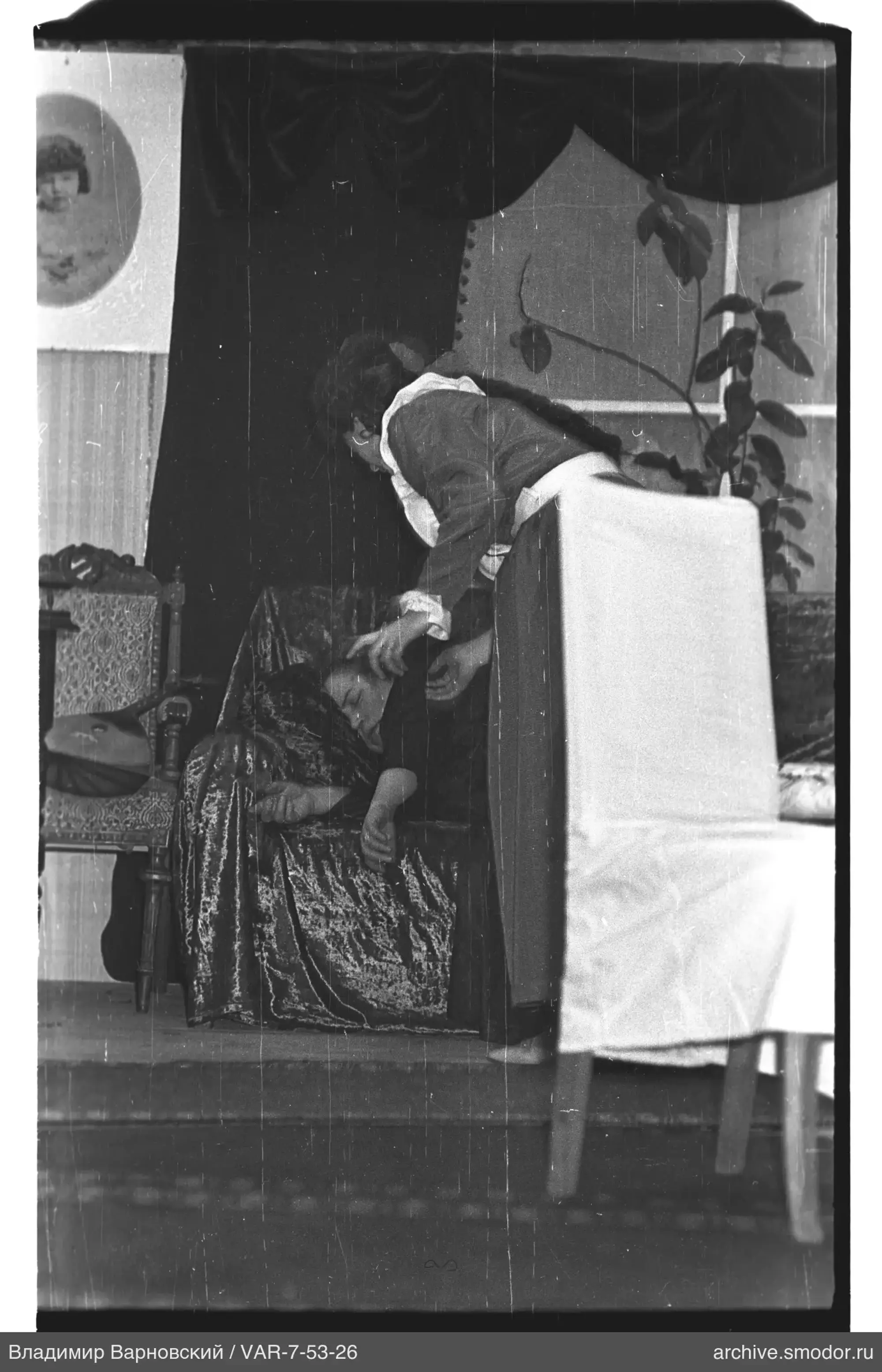 Woman leaning over another woman in a chair