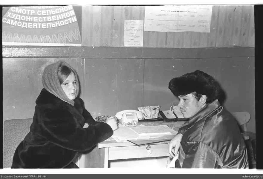 People sitting at a table with papers