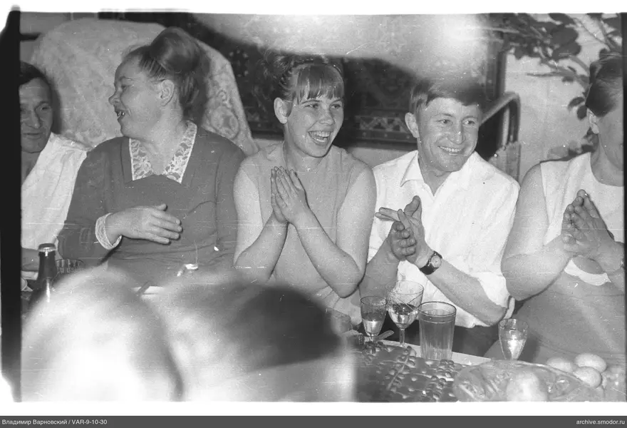 Group sitting at a table with food and drinks