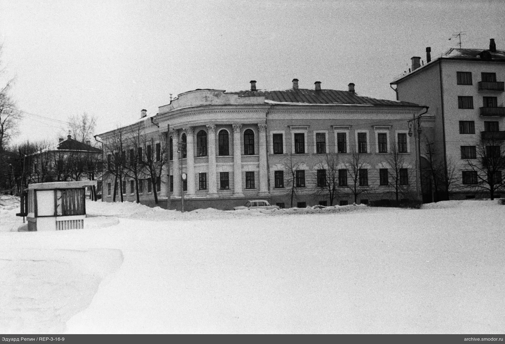 Two-story building with columns and arches