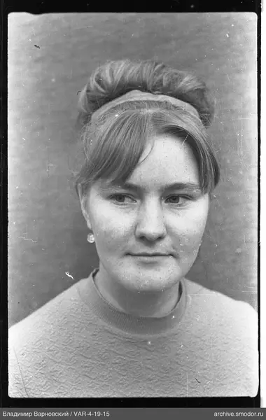 Portrait of a woman with a bun and earrings