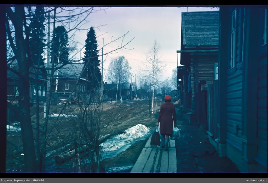 Woman in red on wooden street