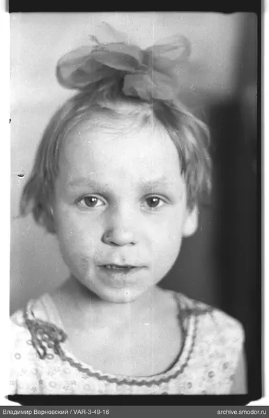 Child's portrait with bow and patterned clothing