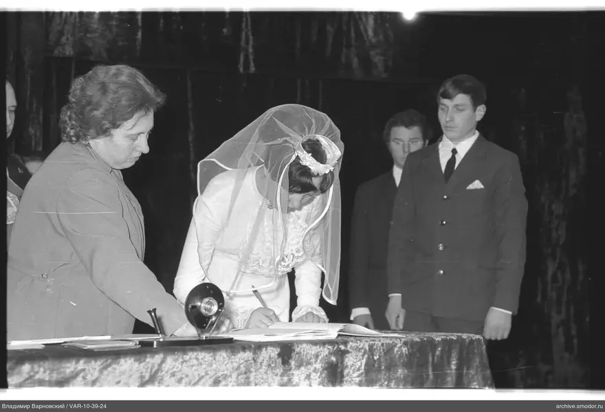 Bride signing a document at the event