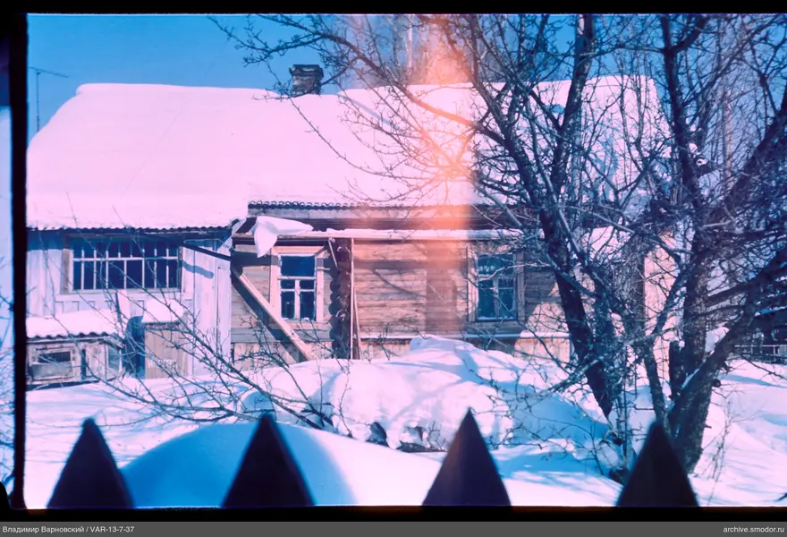 Wooden house with snow-covered roof