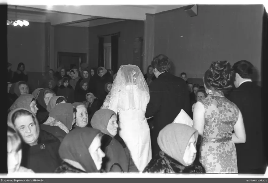 Woman in white dress and veil with man