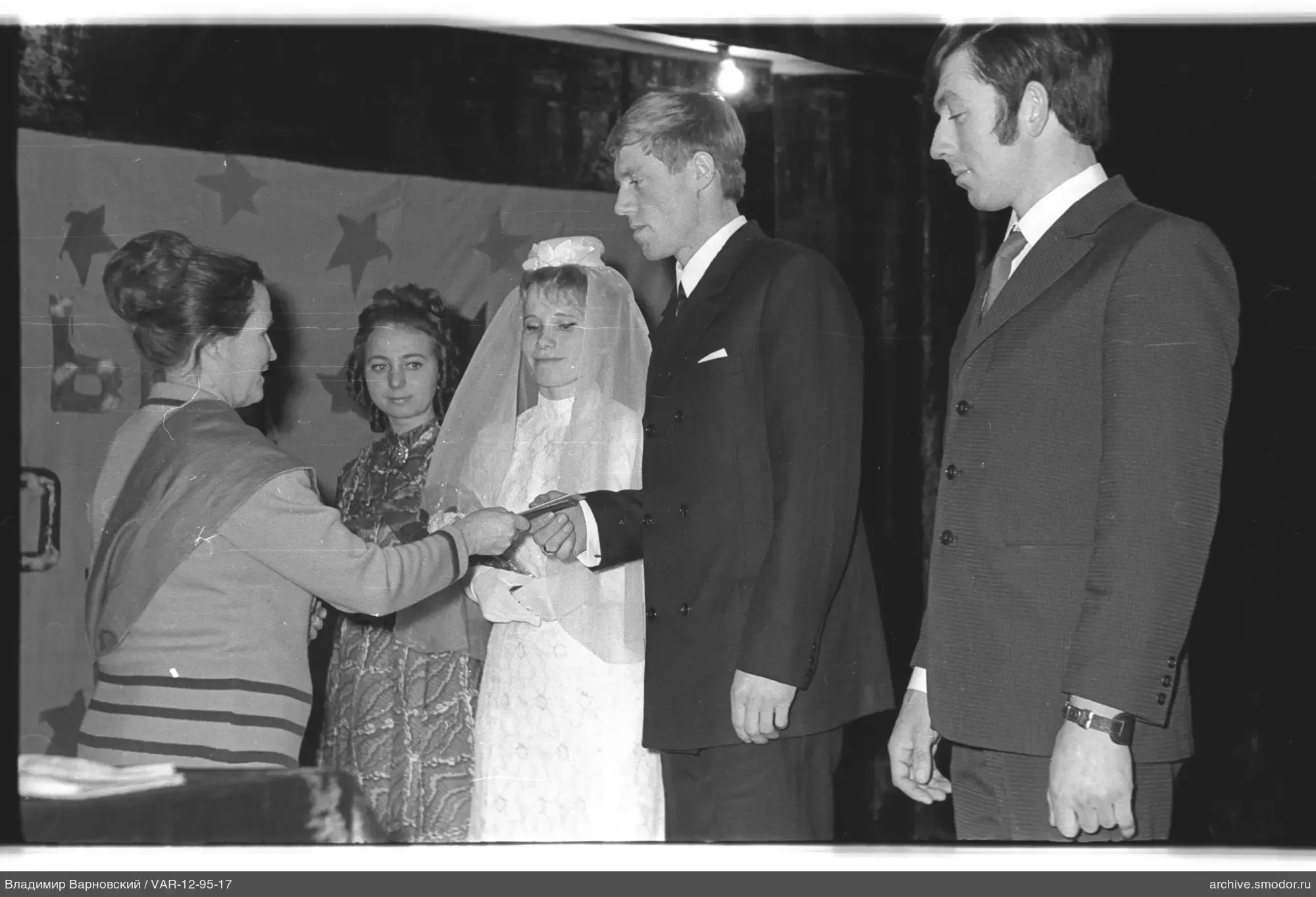 Woman handing a document to a man