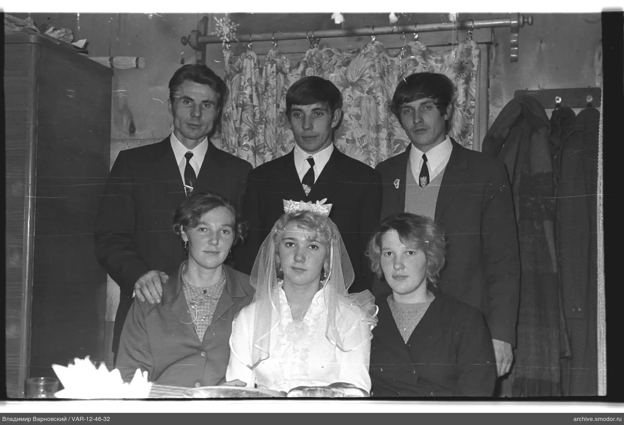 Group portrait with woman in white dress and veil