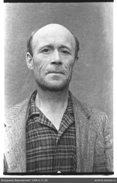 Portrait of a balding man in a light jacket
