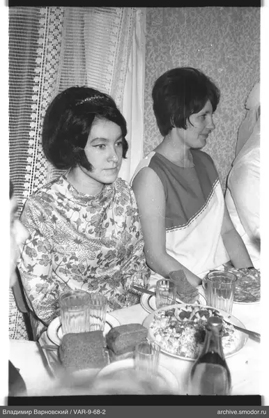 Two women at a table with food