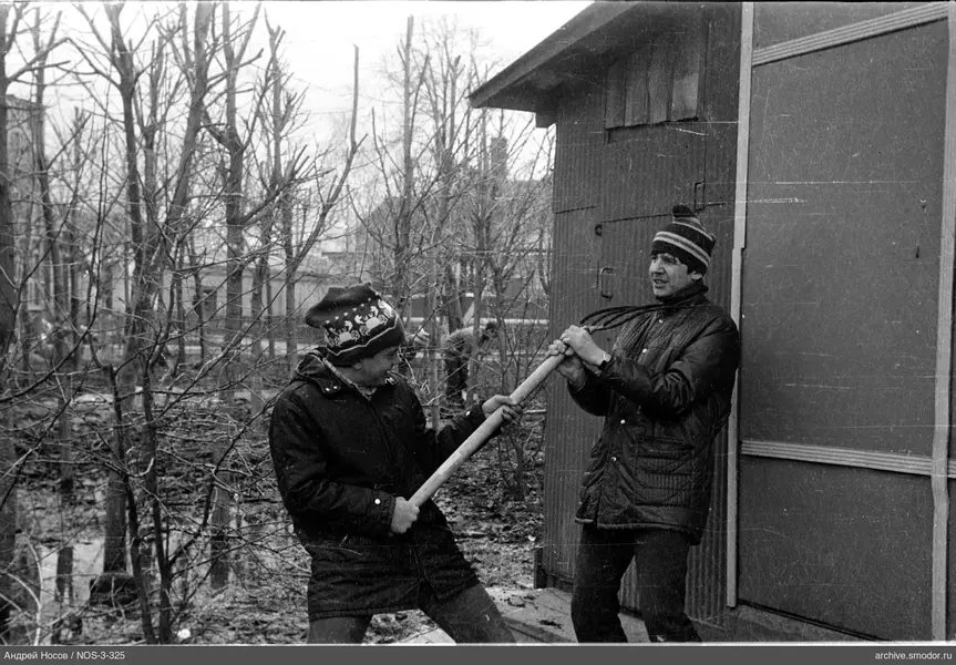 Два мужчины у деревянного здания