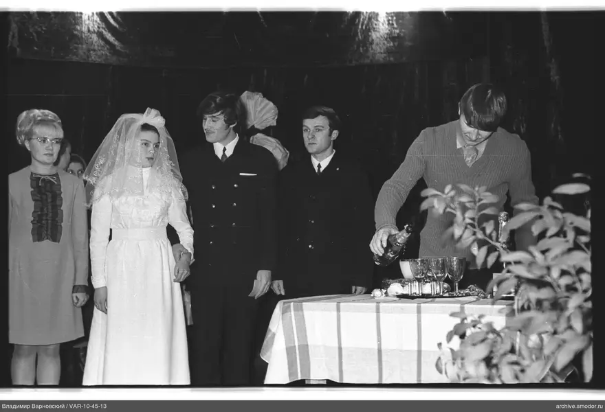 Group portrait with drinks and woman in headdress