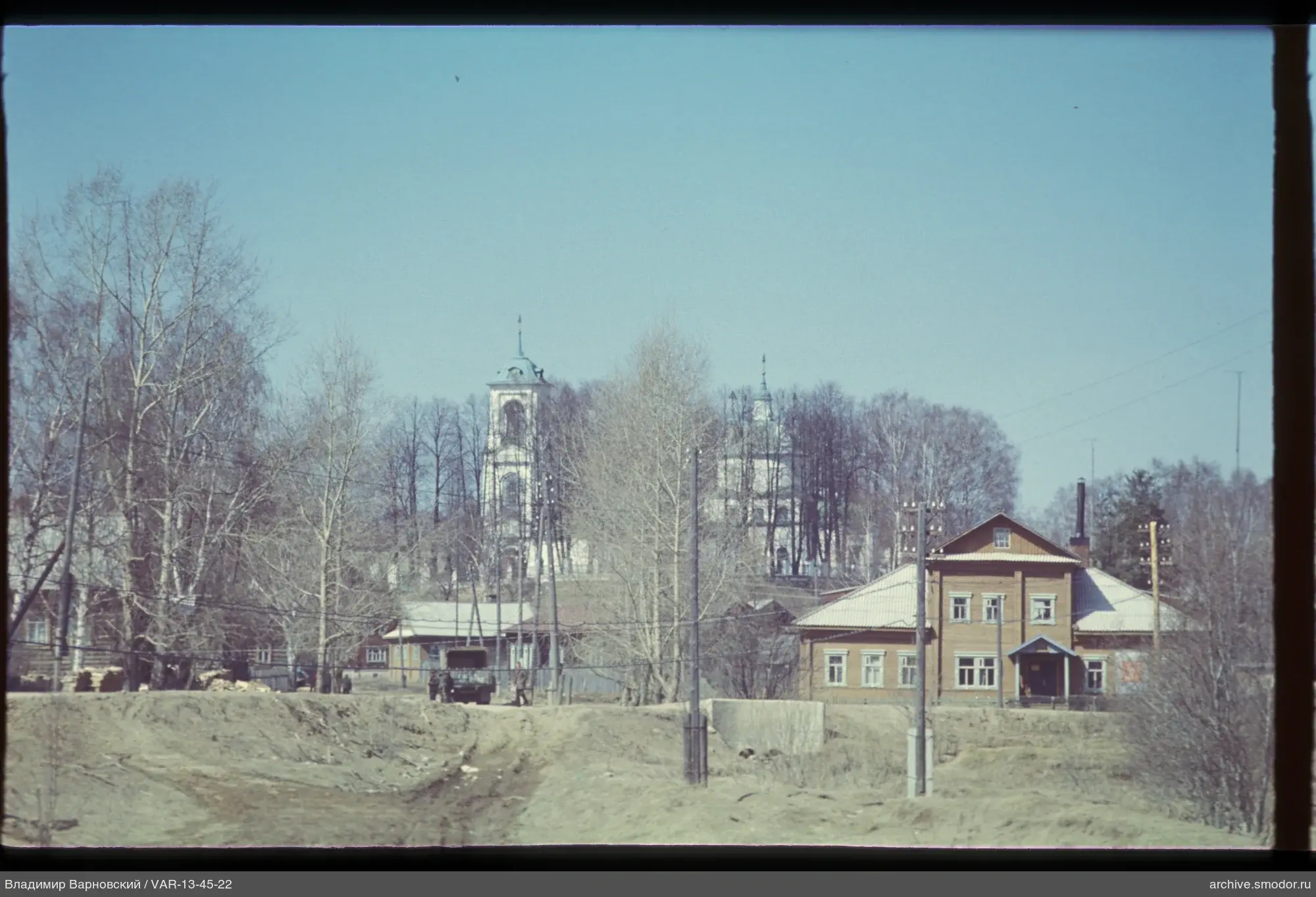Wooden building and church in landscape