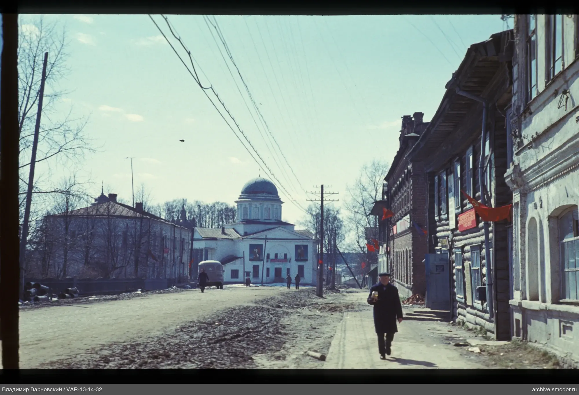 Street scene with man carrying a can
