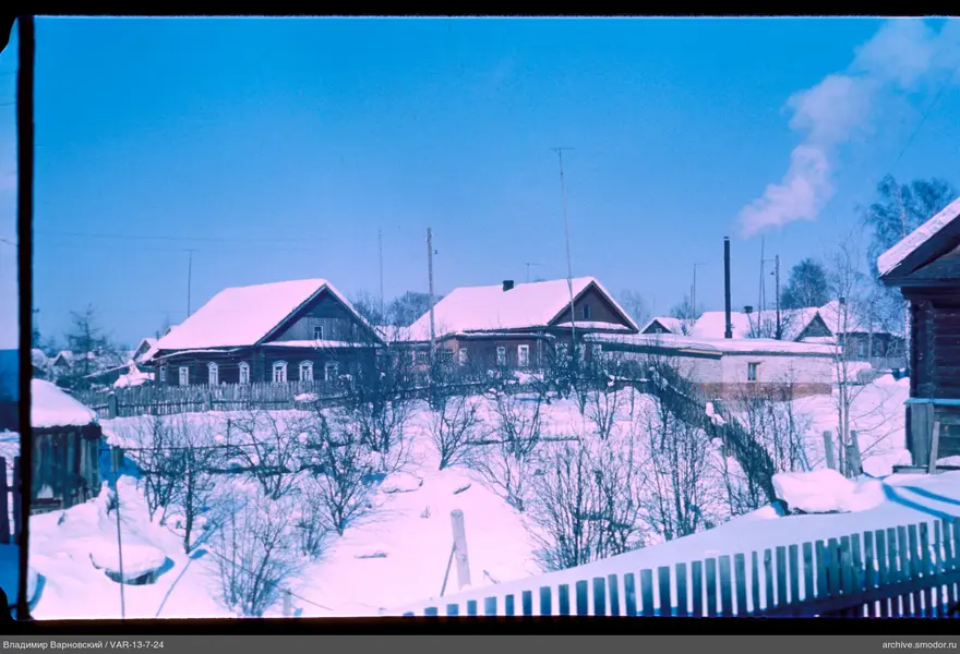 Wooden houses with snow-covered roofs