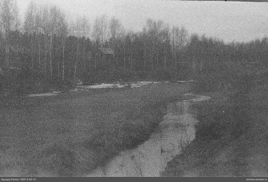 Fluss mit gewundenem Ufer und laublosen Bäumen