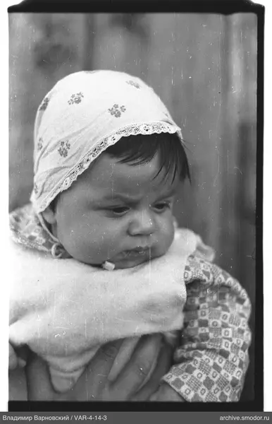Child portrait with headscarf and fur vest