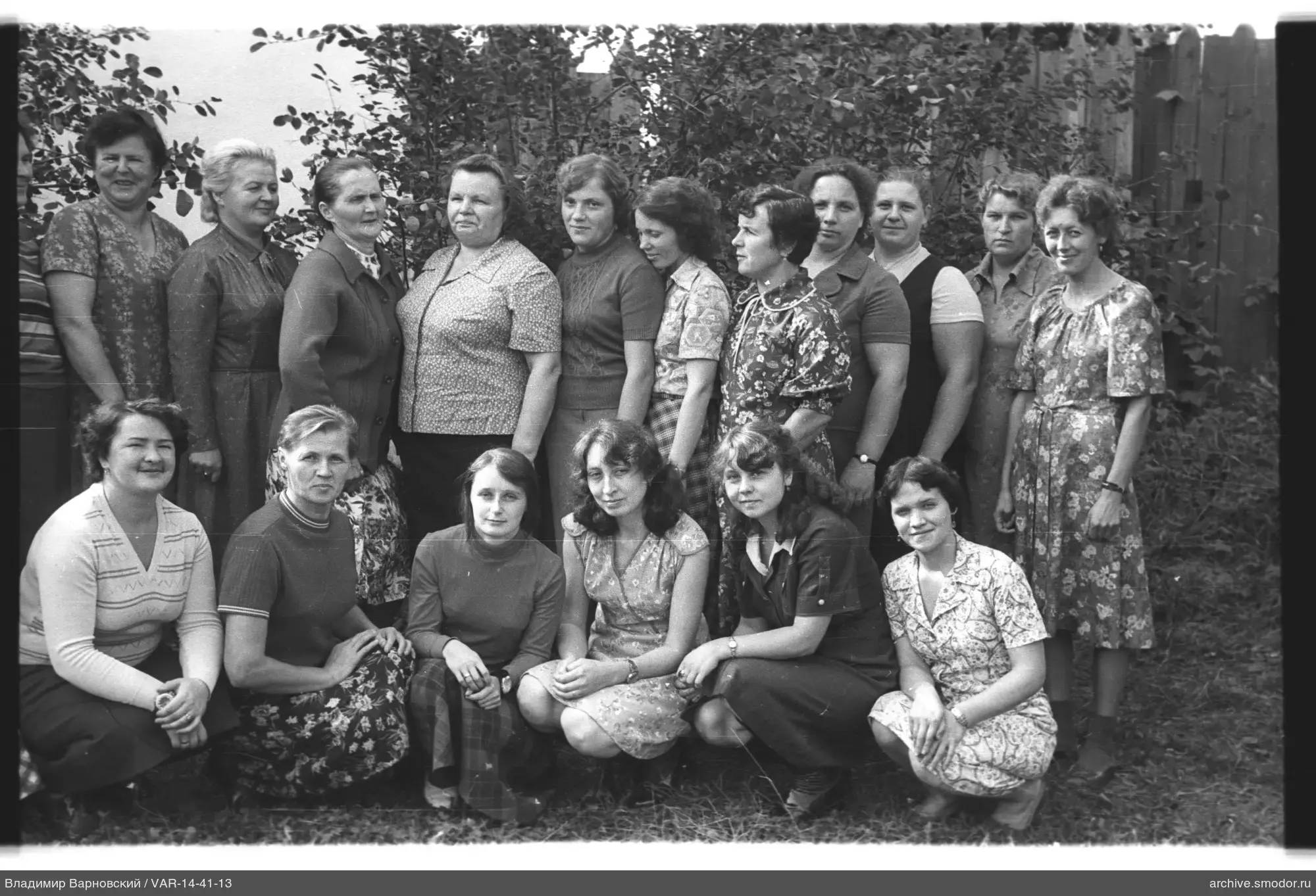 Group of women against wooden fence