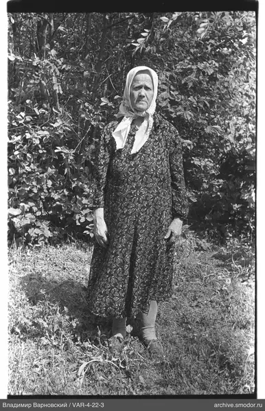 Woman in dress and headscarf outdoors