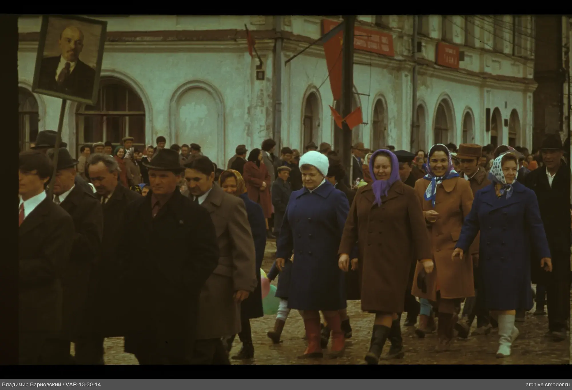 Group of people in front of a building with flags