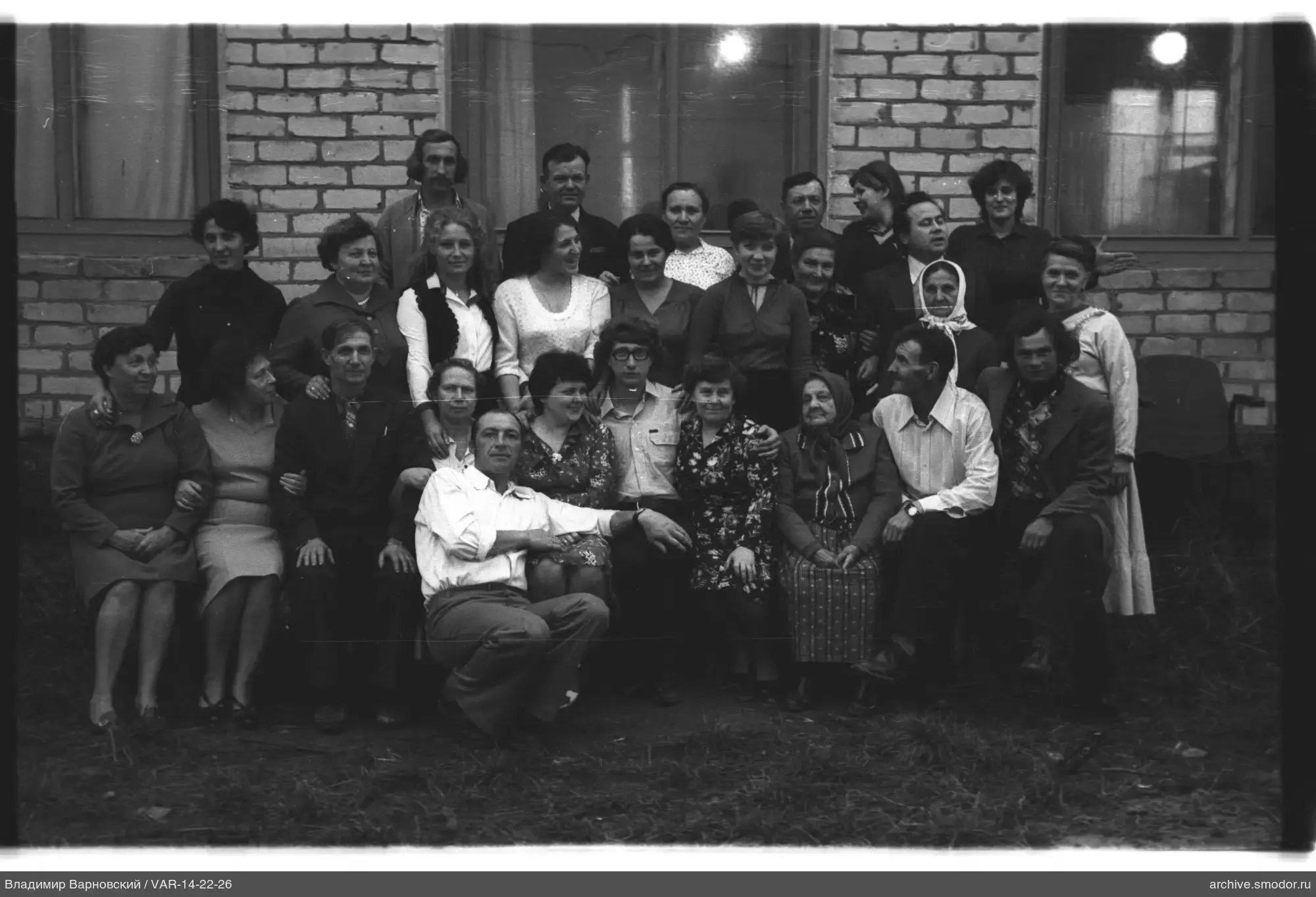 Group portrait on the grass near a brick building