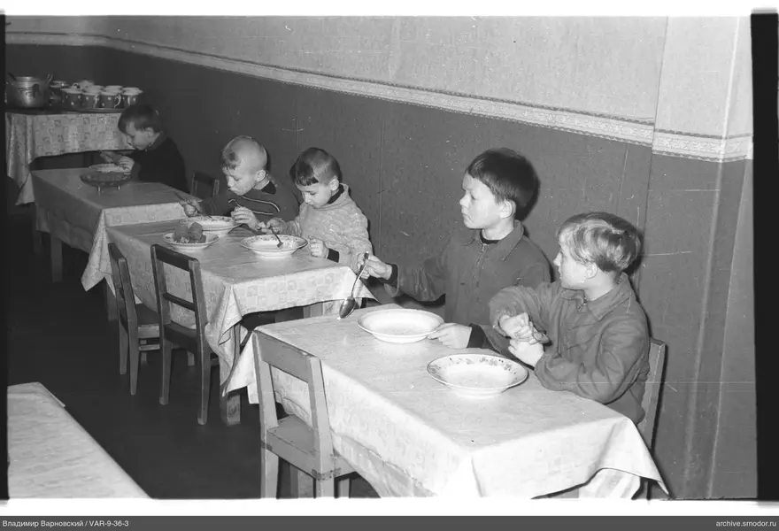 Five boys sitting at tables