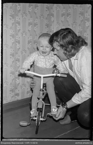 Child on a bicycle with training wheels crying