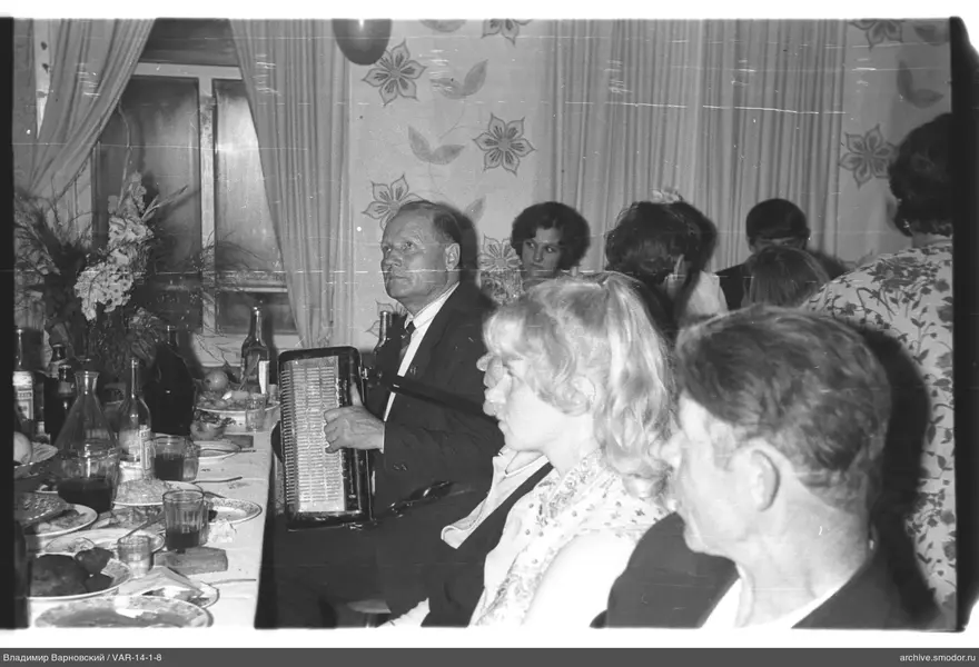 Man playing accordion at the table