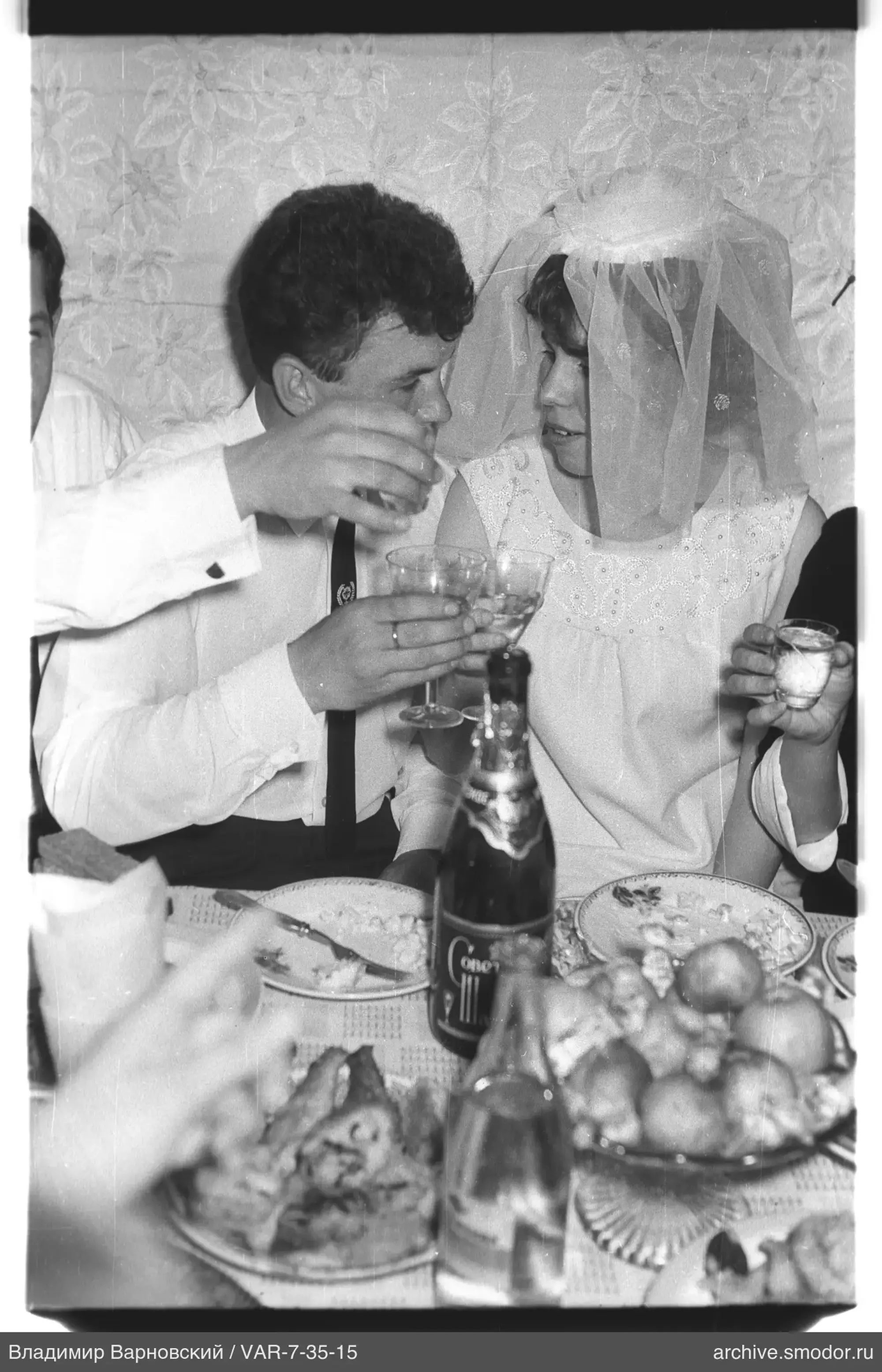 Man and woman raising glasses for a toast