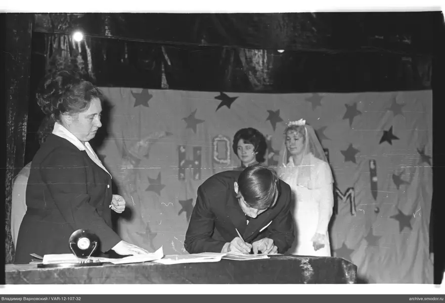 Man writing at a table during an event