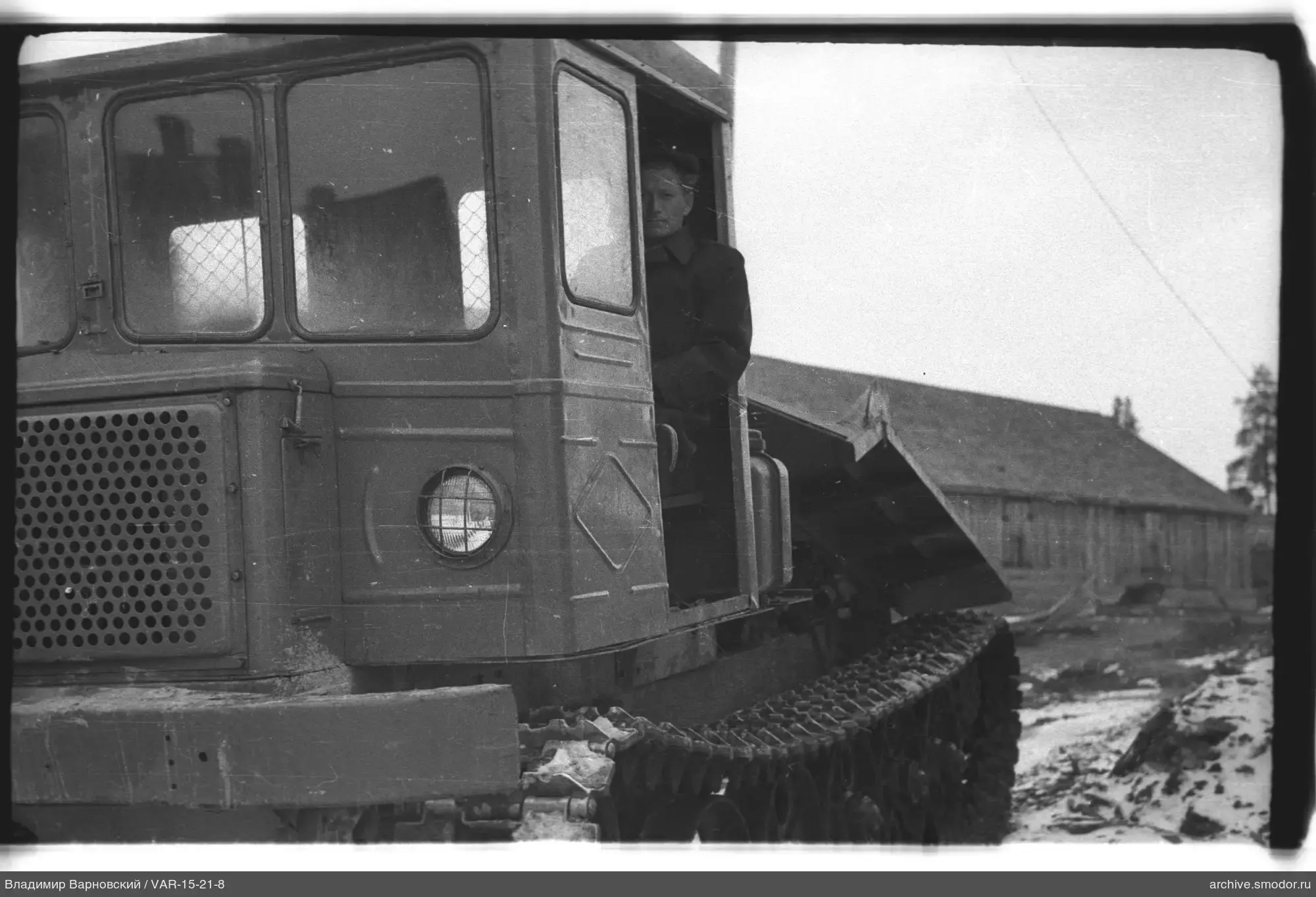 Man in tracked cargo vehicle cabin