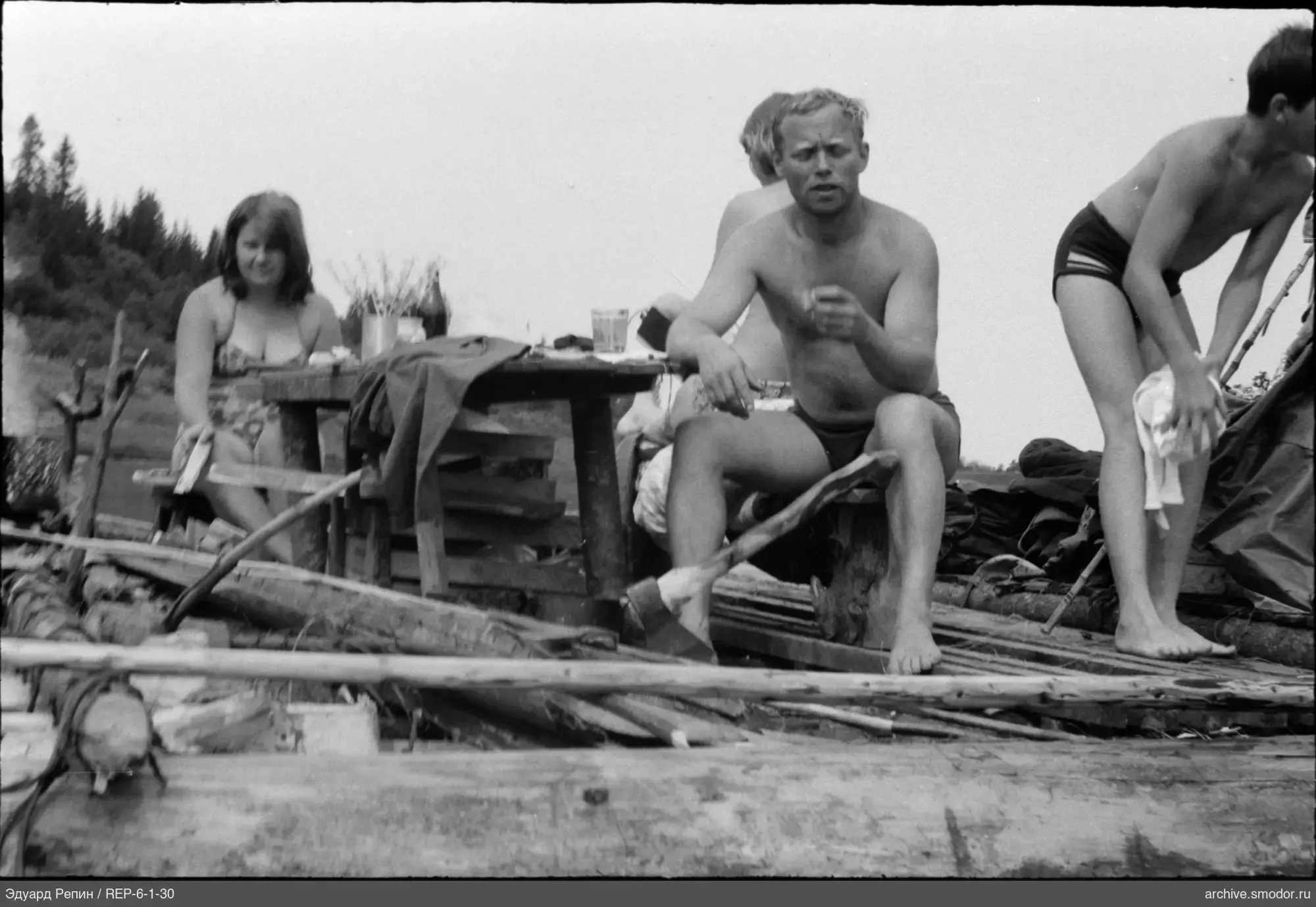 People in swimsuits on a wooden platform