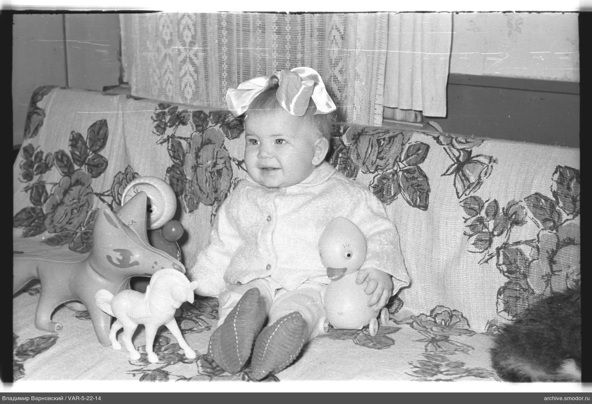 Child with toys on sofa
