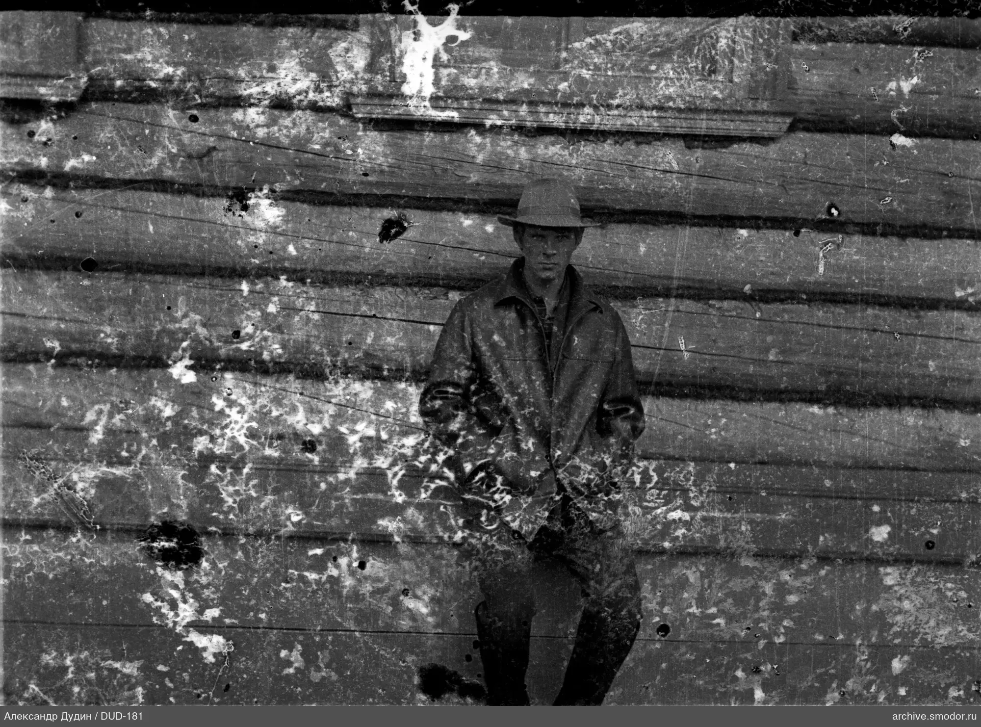 Man by a wooden wall