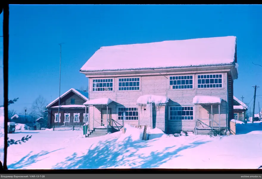 Two-story wooden building with snow