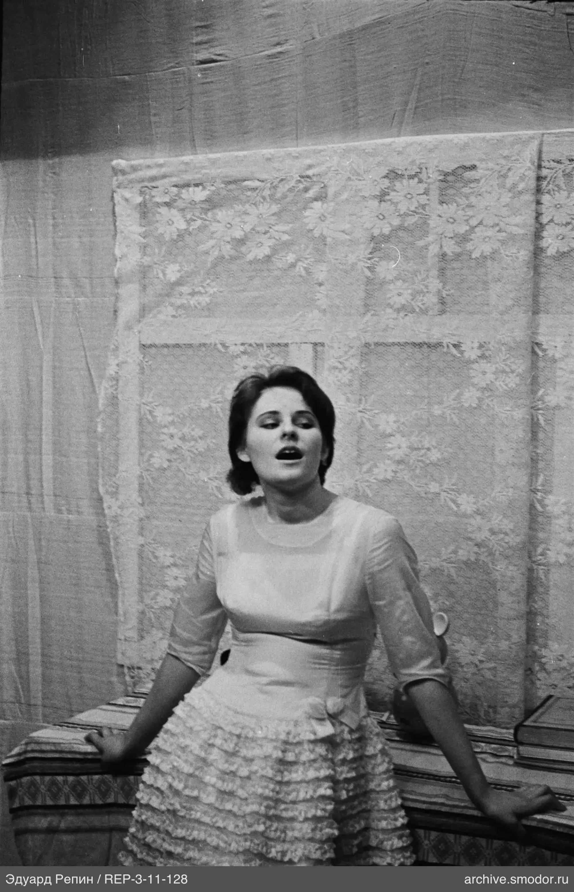 Woman in light dress on bed