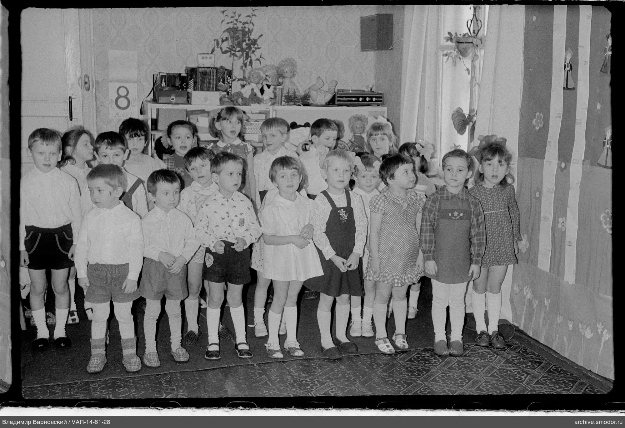 Group portrait of children in a room