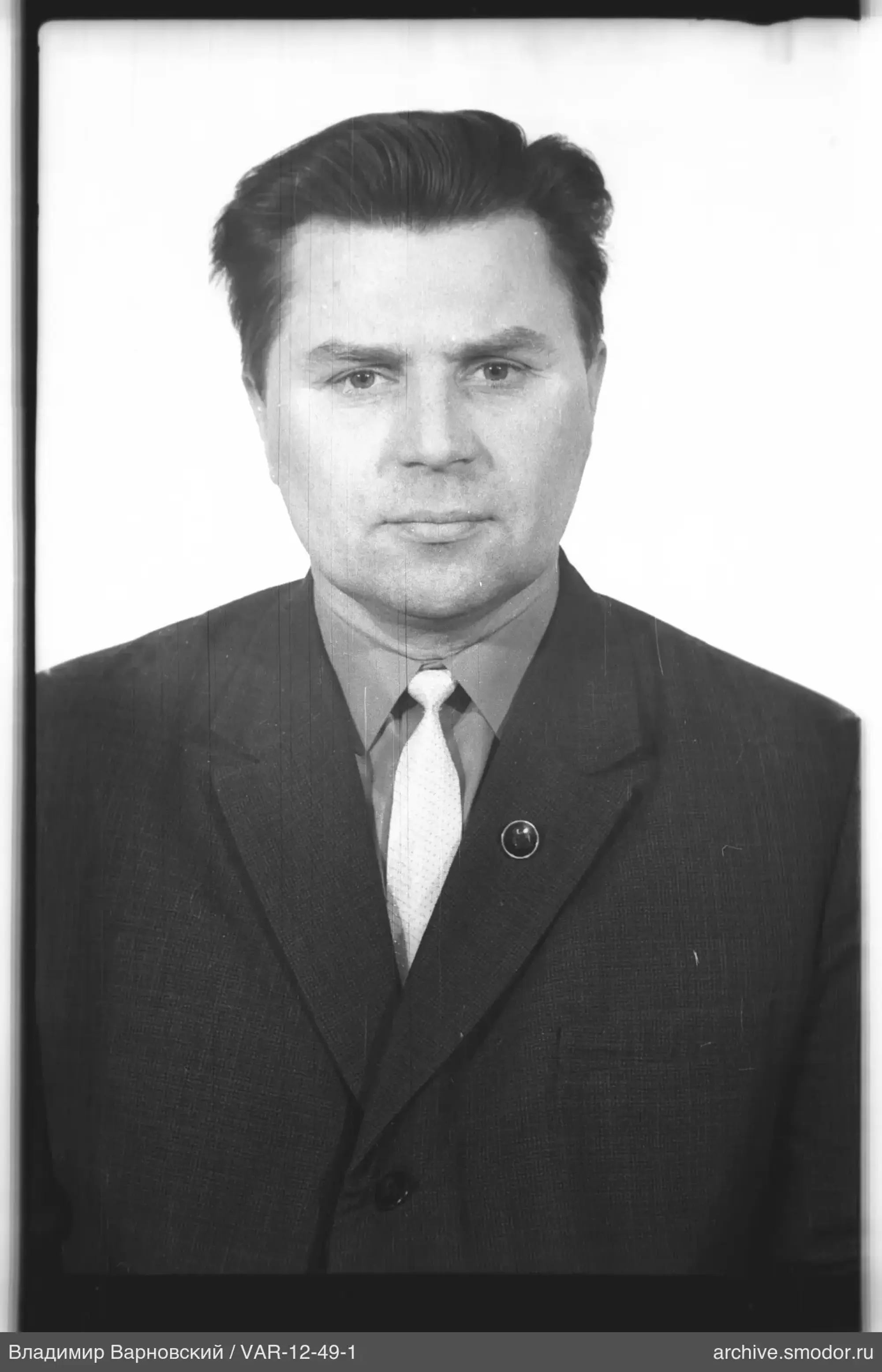 Portrait of a man in a suit with badge