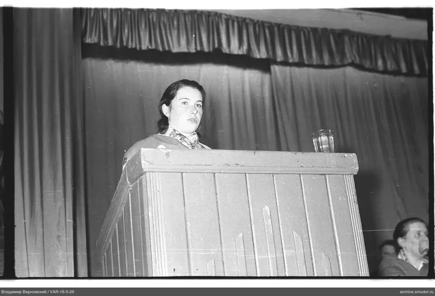 Woman at a wooden podium during an event