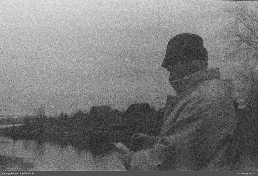 Profil eines Mannes vor Fluss und Häusern
