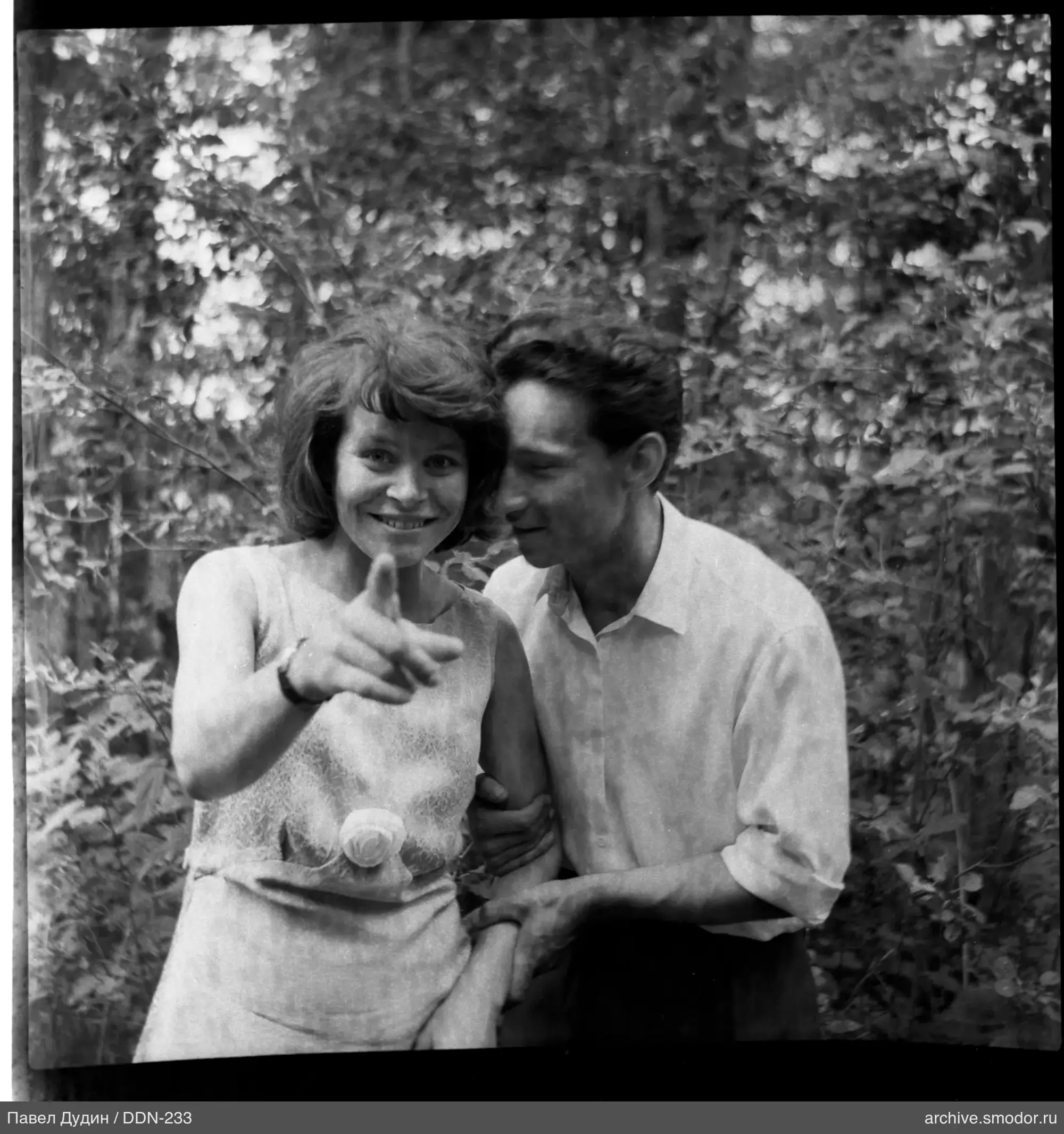Group with woman and man against foliage