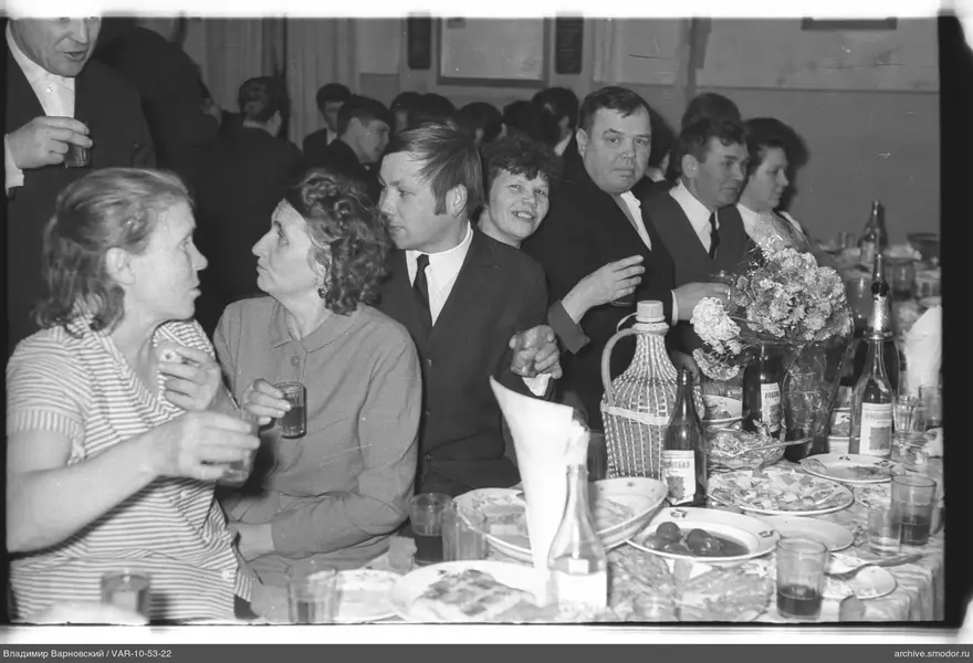 Group sitting at a table with dishes and drinks