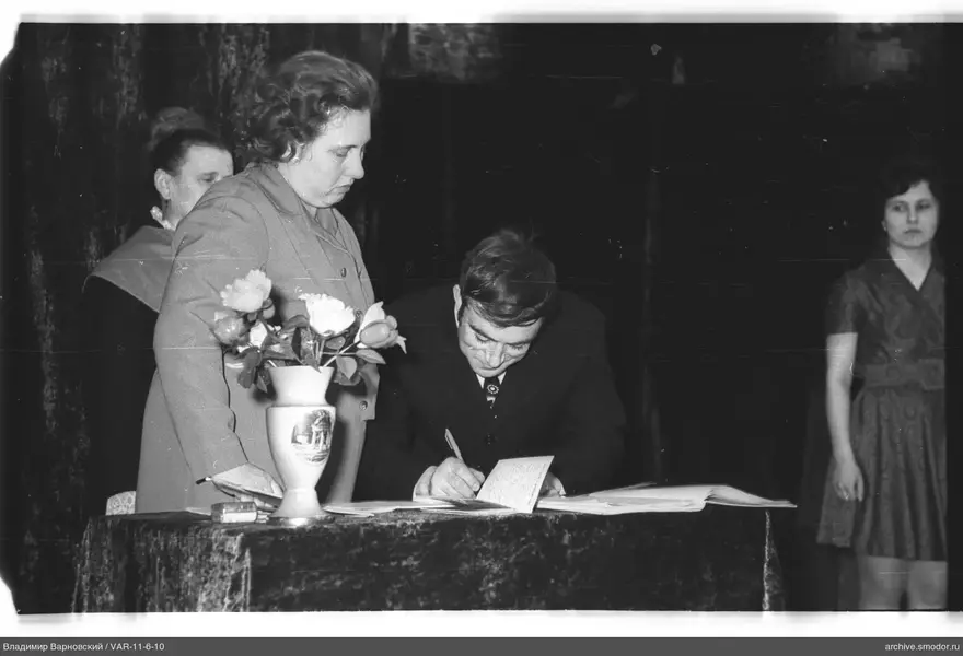 Man writing at a table during an event