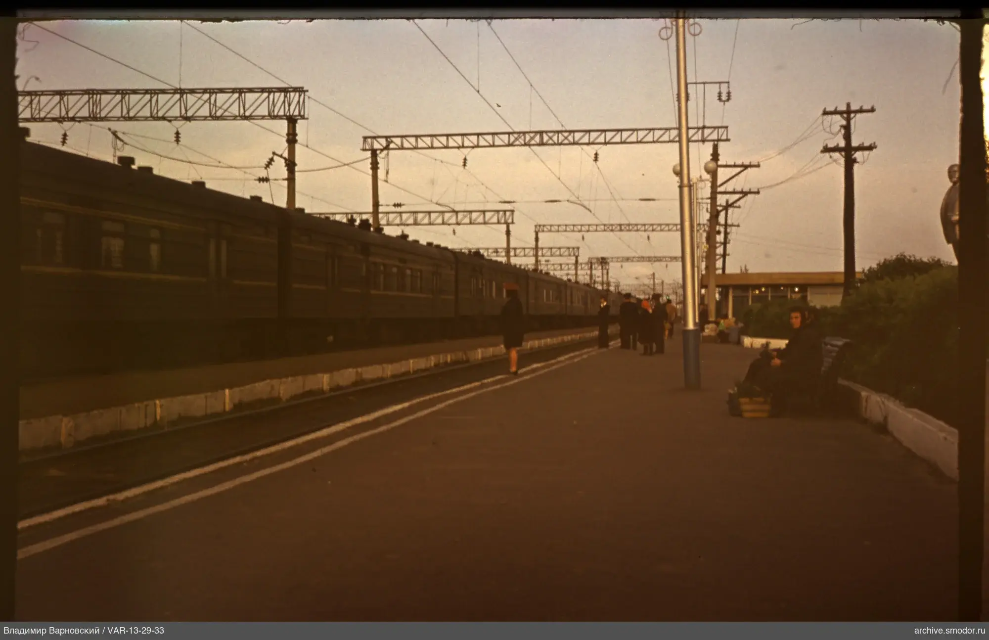 Railway station with train and people